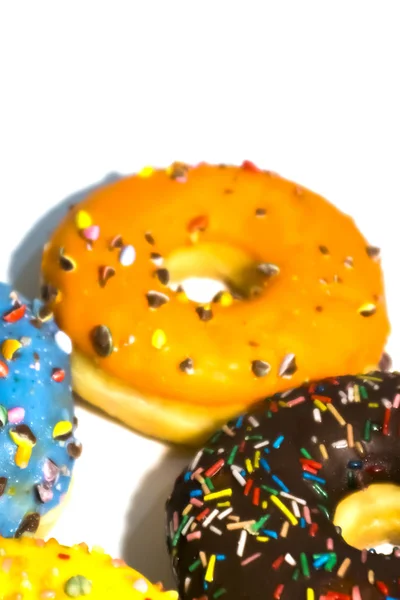 Sweet tasty donuts with colorful sprinkles isolated on white bac — Stock Photo, Image