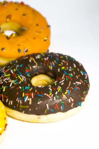 Sweet tasty donuts with colorful sprinkles isolated on white bac — Stock Photo, Image