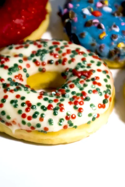 Sweet tasty donuts with colorful sprinkles isolated on white bac — Stock Photo, Image