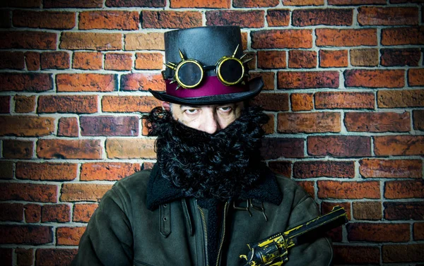 Steampunk man with beard, hat and glasses on background of vinta