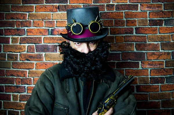 Steampunk man with beard, hat and glasses on background of vinta