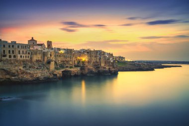 Polignano a Mare village on the rocks at sunset, Bari, Apulia, southern Italy. Europe. clipart