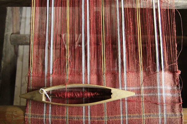 上部に敷設木製の織りシャトルと織機の赤い糸 — ストック写真