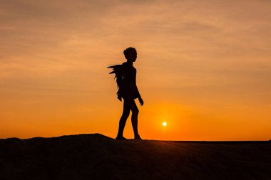 Gün batımı ya da gündoğumu arkaplan ve kopyalama alanı olan kız dansçı silueti. 