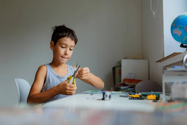 Sötét Hajú Fiú Rajzol Egy Képet Ceruzával Miközben Fehér Asztal — Stock Fotó
