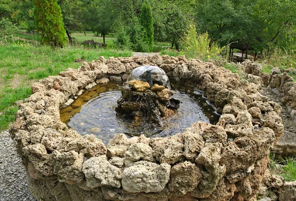 Small stone fountain on top of hill, looking down — Stock Photo, Image