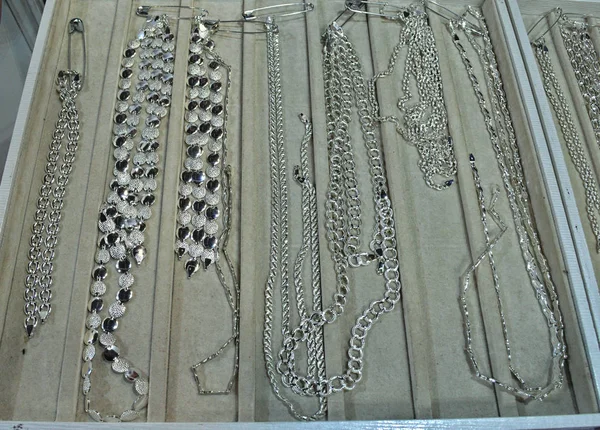 Silver necklaces in showcase for retail sale — Stock Photo, Image