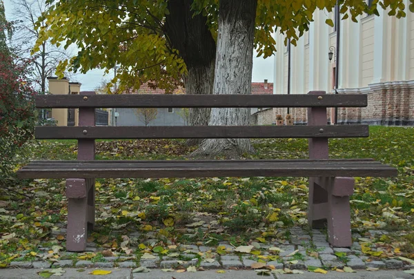 Bench in church yard in Kac, Serbia