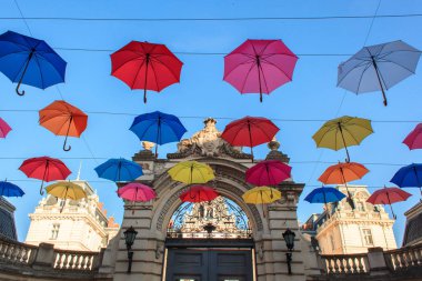 Lviv, Ukraina, June 7, 2018. Coloruful umbrellas urban street decoration. Colored umbrella hang on the city streets clipart