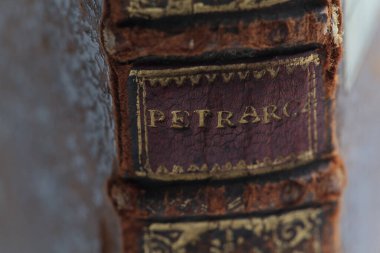 Il Petrarca, old leather book spine. closeup spine detail. Shallow depth of field clipart