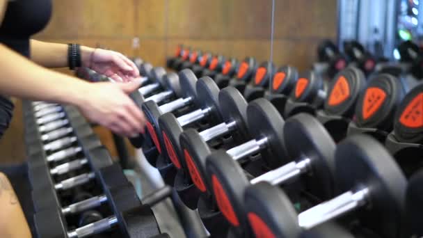 Athlete Woman Takes Dumbbells Rack Gym Hands Close — Stock Video