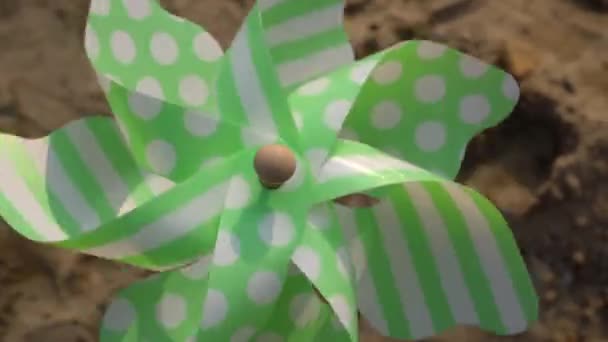 Pinwheel Rotates Close Sand Background — Stock Video