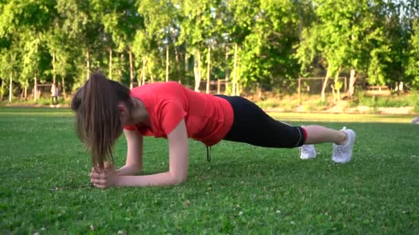 Sports Girl Makes Plank Exercise Lawn Park — Stock Video