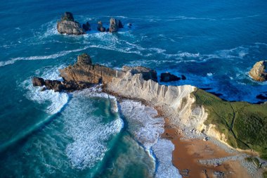 aerial view of amazing rock formations on the Arnia beach, Costa Quebrada, Cantabria, Northern Spain clipart