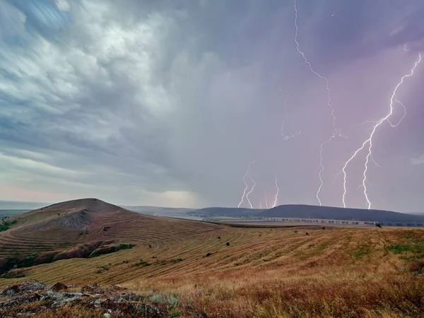 Thunderstorm with lightnings over the fields, long exposure image
