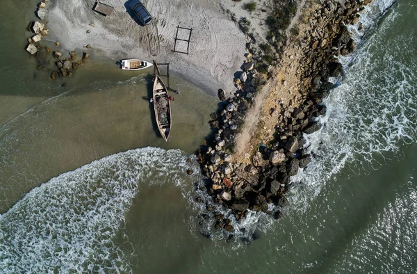 aerial view of lonely wooden fishing boat at shore, Vadu, Romania