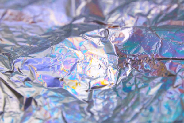 Holographic iridescent foil texture background. It can be used for posters, cards, flyers, brochures, magazines and any kind of cover