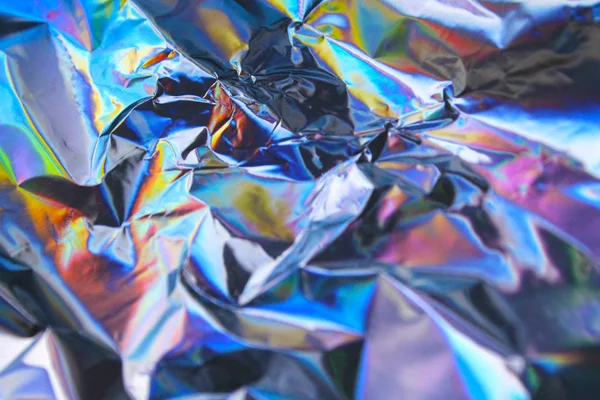 Holographic iridescent foil texture background. It can be used for posters, cards, flyers, brochures, magazines and any kind of cover