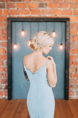 Çiçek ve dekorla düğün kemerinin önünde güzel bir gelin. Buket ellerde ve detaylarda. Kız mutlu, gülümsüyor ve dans ediyor. Modern tarzda bir gelinlik hayal et.