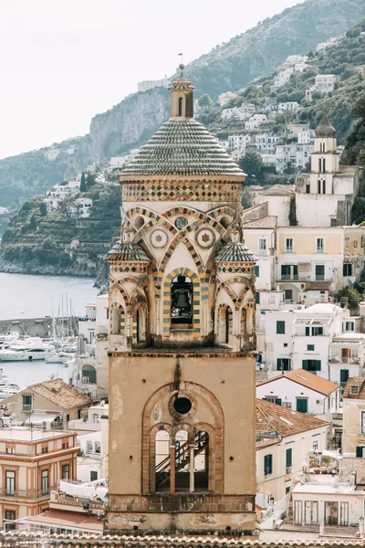 Amalfi coast in Italy, the most beautiful city. Streets and old architecture, narrow passages, shops and cafes. View from the sea and above. Panoramic view of the mountain slopes