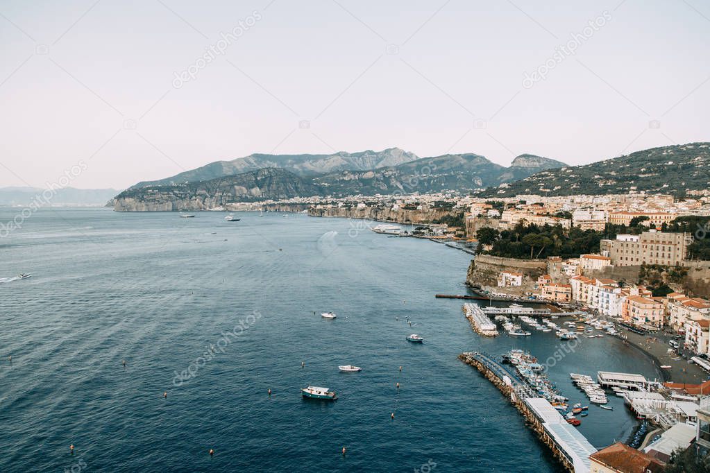 Views of the city of Sorrento in Italy, panorama and top view. Night and day, the streets and the coast. Beautiful landscape and brick roofs. Architecture and monuments of antiquity. Shops and streets with fountains and sculptures.