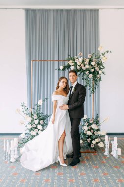 Şık Avrupa düğün töreni. Gelin ve damat konuklar tarafından çevrili. Arch ve taze çiçek dekorasyonu.