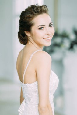 Güzel gelin beyaz bir stüdyoda. St. Petersburg'daki Rus düğün. Portre ve güzel sanatlar stil detayları.