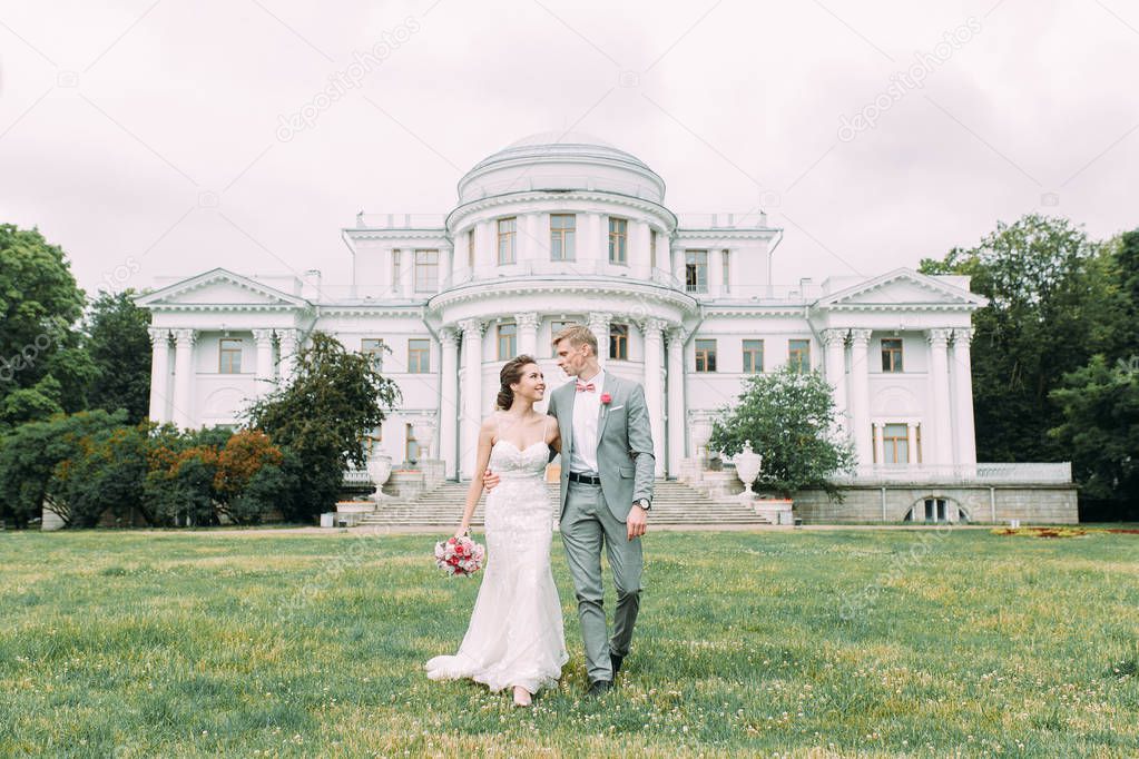 Stylish wedding in St. Petersburg. Elagin island and castle in the background. Walking photo session of the couple.