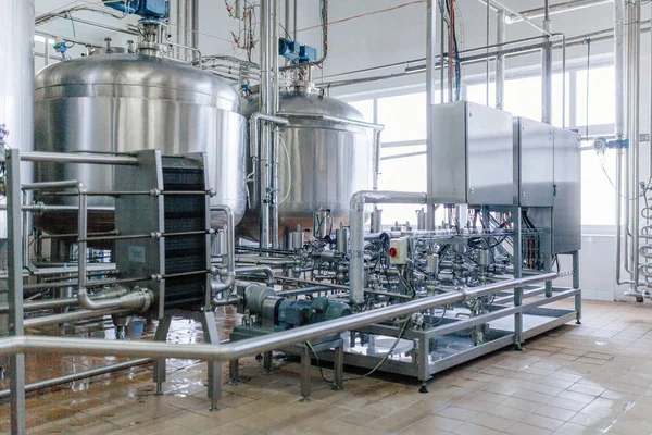 Production of milk and yogurt at the plant. Metal units and tanks for storage and transportation.