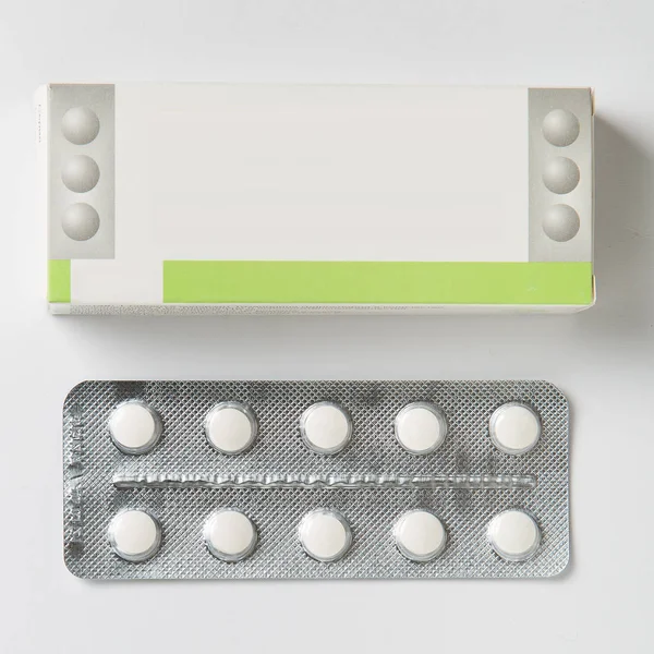 Set of blister packs of pills on white background. Pack of pills in a pile.
