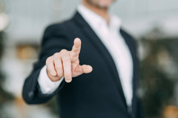 The businessman points his finger at the screen, presses and taps. Blank for the designer to hand.