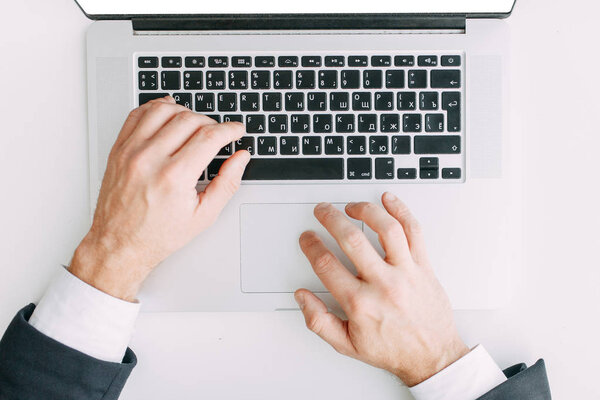 Hands at work on a laptop with bokeh. Business situation, isolated background.
