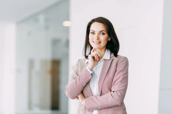 Beautiful business girl on light office background. Business coach and coach of success.