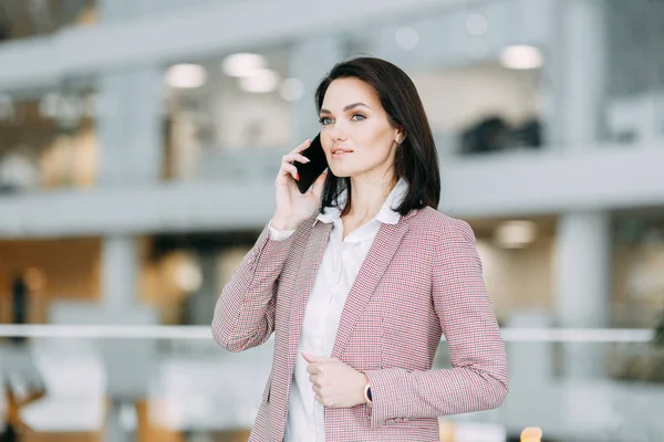 Girl blogger calls on the phone and agrees. Emotional portraits at work.