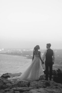 Düğünde dağlarda günbatımı Kıbrıs plaj. Mutlu çift ve güzel bir manzara.