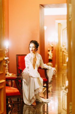 Gelinin ücretleri bir buket ile lüks otel. Gelin boudoir elbiseli sabahlık.