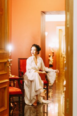 Gelinin ücretleri bir buket ile lüks otel. Gelin boudoir elbiseli sabahlık.