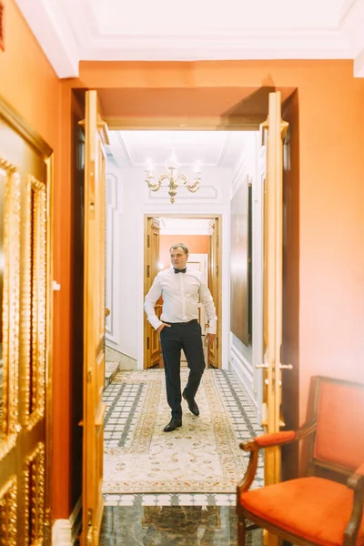 The preparations of the groom in a Deluxe hotel. the man in the shirt and jacket.