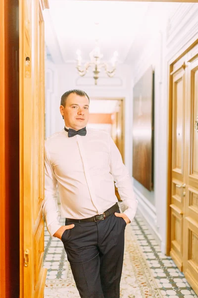 The preparations of the groom in a Deluxe hotel. the man in the shirt and jacket.