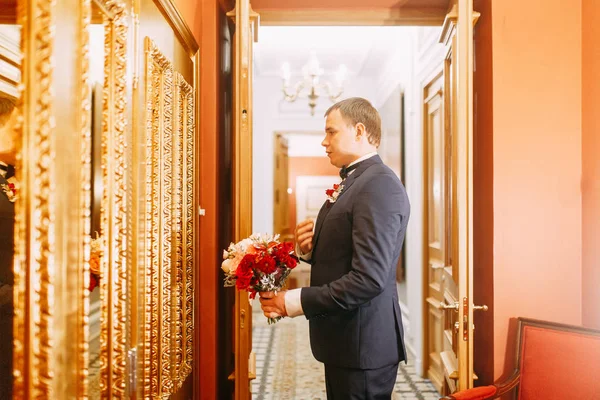 The preparations of the groom in a Deluxe hotel. the man in the shirt and jacket.