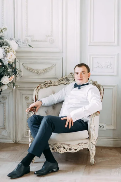 The preparations of the groom in a Deluxe hotel. the man in the shirt and jacket.