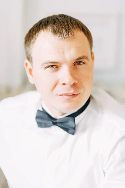 The preparations of the groom in a Deluxe hotel. the man in the shirt and jacket.