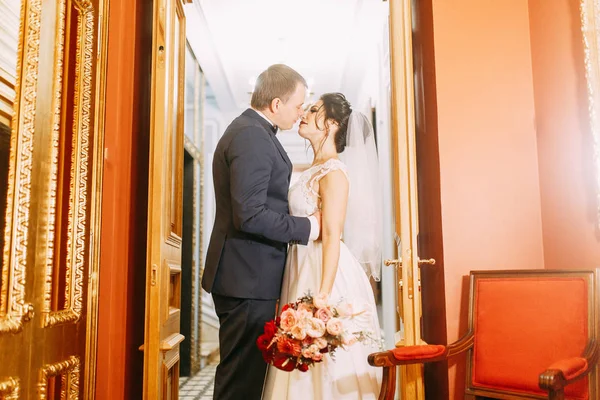 Meeting the newlyweds in the Studio and hotel. Bride and groom with a bouquet.