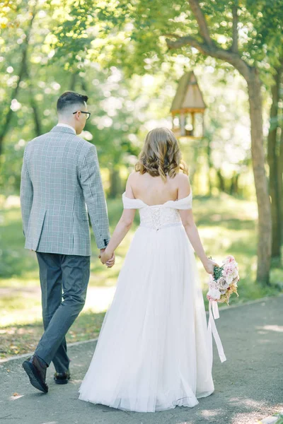  The wedding couple is walking along the Park. Photo shoot in the European style in nature.