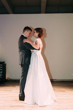 The first dance of a young couple. Wedding traditions in European style.