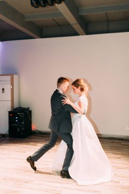 The first dance of a young couple. Wedding traditions in European style.