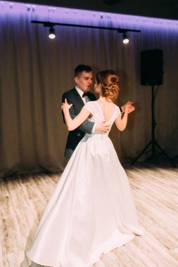 The first dance of a young couple. Wedding traditions in European style.