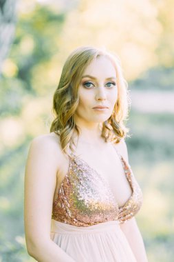 Aerial photo shoot at sunset in the forest. Girl in a flying dress in the style of fine art.