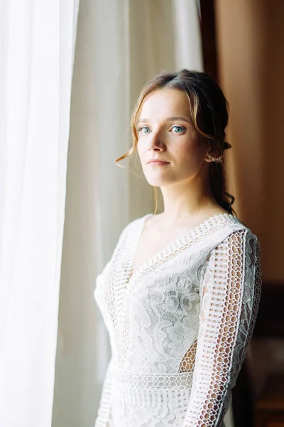Bride fees at the hotel in the European style. Boudoir photo shoot and wedding dress.