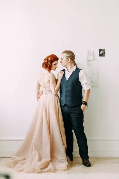 Meeting the newlyweds in the Studio and hotel. Bride and groom with a bouquet.